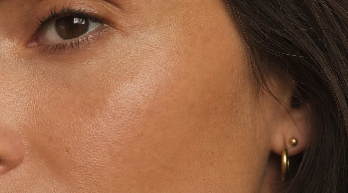 Close-up of smooth skin texture on cheek and temple area